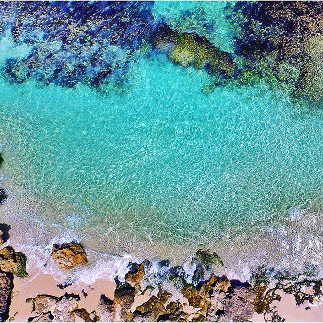 Green blue water framed by rocks and reef